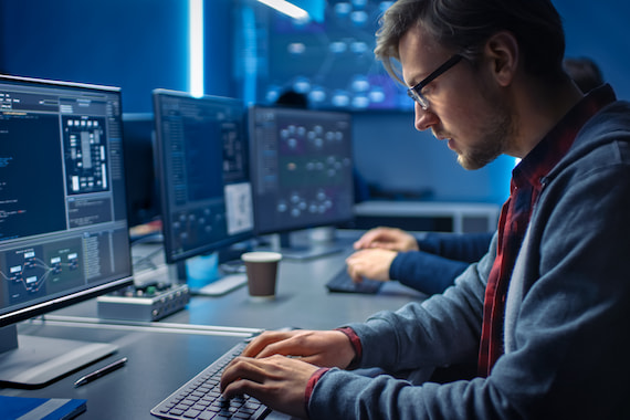 Software developer upgrading code on custom software development